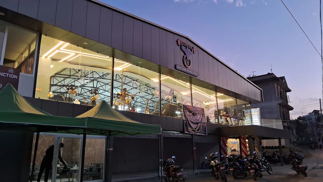 Fitness 24x7 gym exterior at dusk